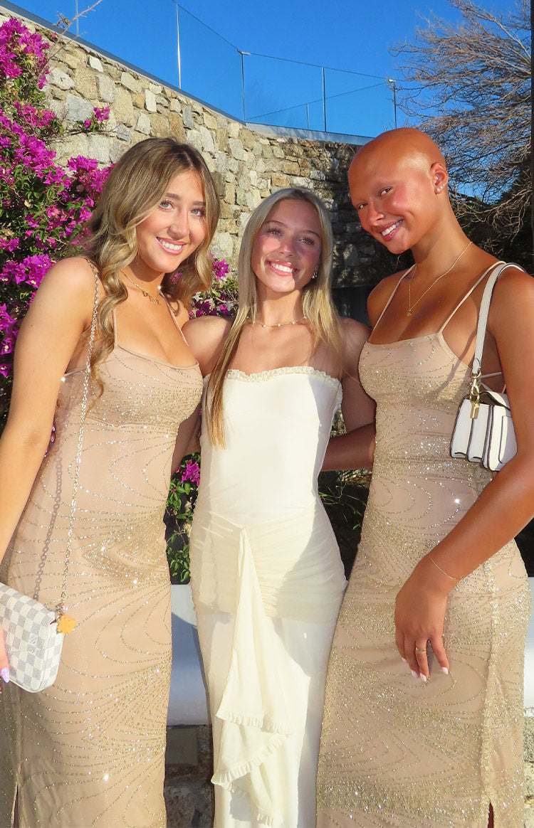 Cream strapless mesh maxi dress with a ruffled neckline and draped ruched fabric detail on the front skirt
