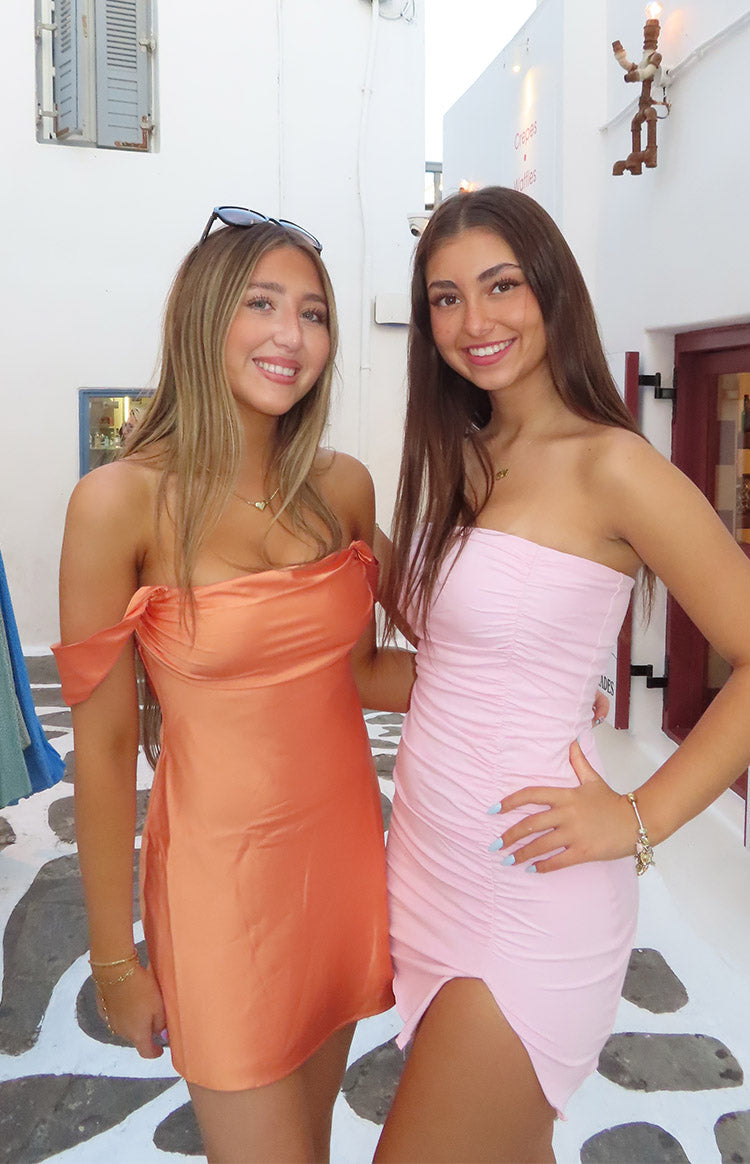 Orange satin off-shoulder mini dress with a draped bust and fitted silhouette