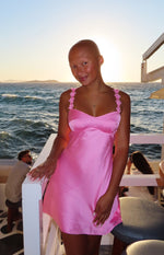 Hot pink satin mini dress with a sweetheart neckline and floral embellished spaghetti straps