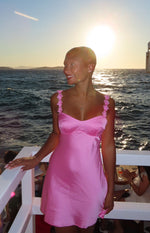Hot pink satin mini dress with a sweetheart neckline and floral embellished straps