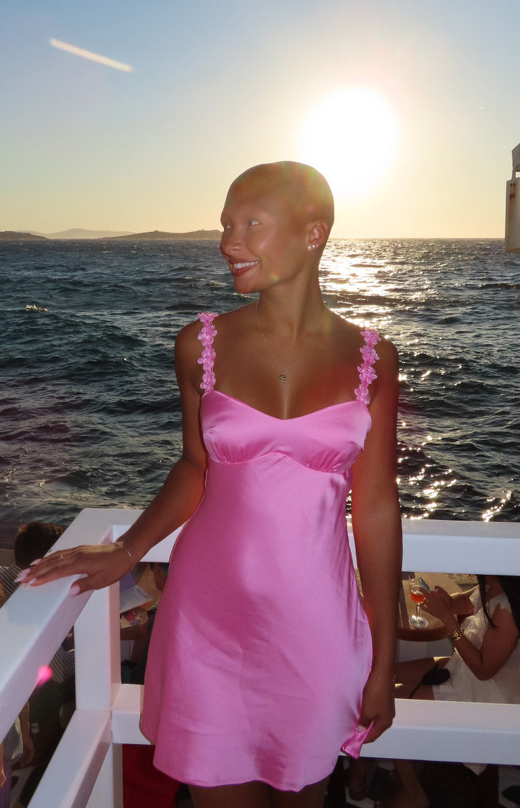 Hot pink satin mini dress with a sweetheart neckline and floral embellished straps