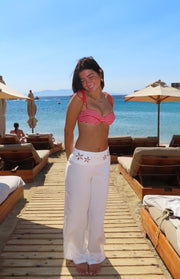 Front view of a red and white striped balconette bikini top with thin tie-shoulder straps