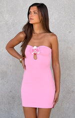 Pink strapless mini dress with a white and pink orchid detail and a small keyhole cutout at the bust