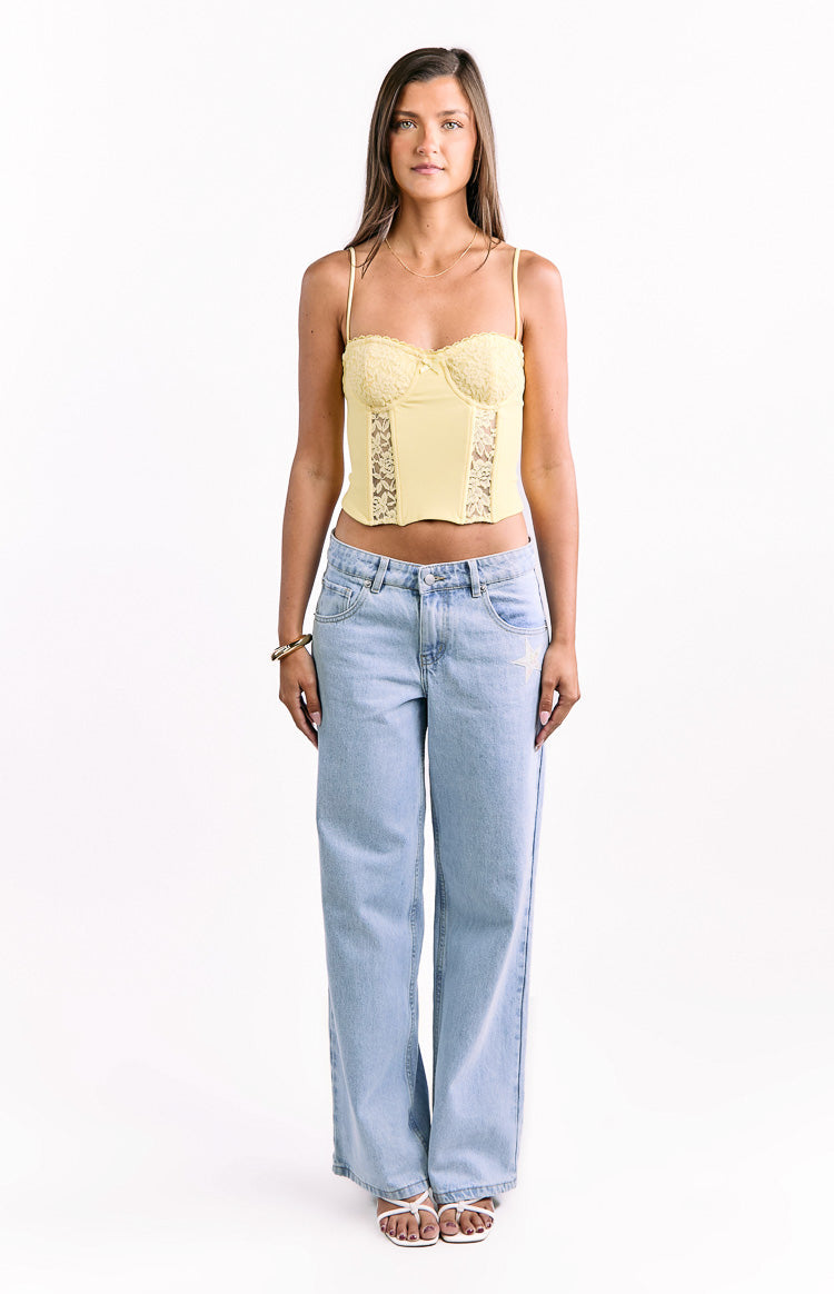 Yellow cropped corset top with lace cups and sheer lace panels on the bodice