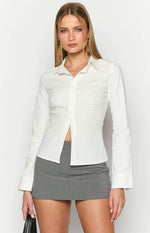 Front view of a white fitted long sleeve shirt with a pointed collar and buttoned cuffs, partially unbuttoned