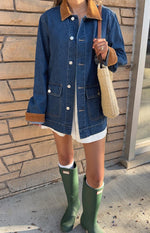 Mid wash denim oversized jacket with brown corduroy collar, large white buttons, patch pockets, and corduroy-lined rolled cuffs