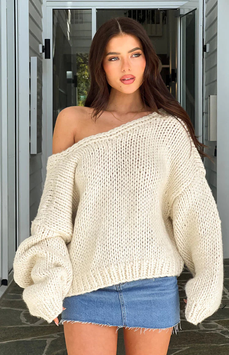 Close-up of a cream chunky knit tie-up cardigan with wide sleeves and an open front