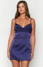 Front view of a navy satin mini dress with a ruched sweetheart neckline and thin spaghetti straps