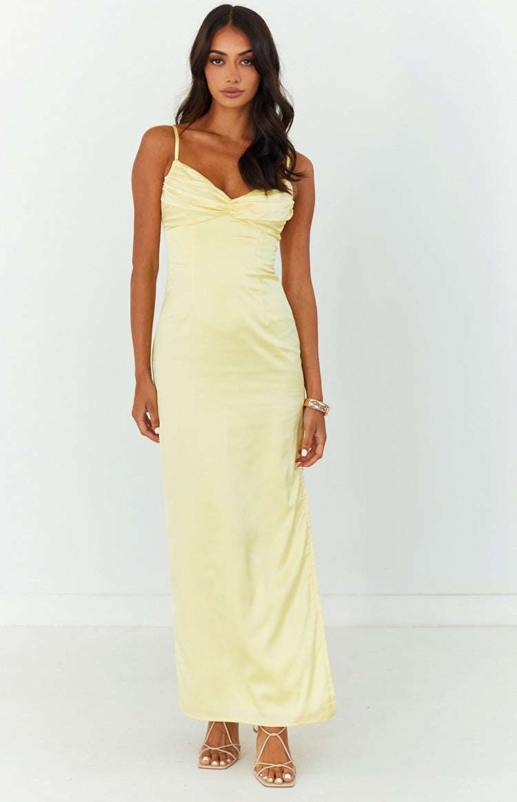 Front view of a honey yellow satin maxi dress with a ruched bust and adjustable ruching detail on the side of the skirt