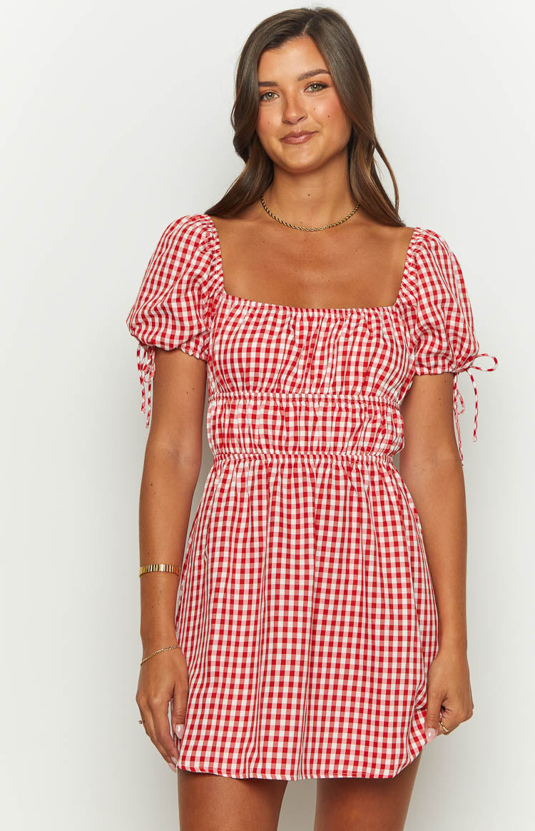 Red gingham mini dress with a square neckline, short puff sleeves with tie details, and a shirred bodice