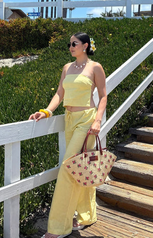 Yellow strapless crop top with a relaxed fit and visible side tie detail in a linen-look fabric