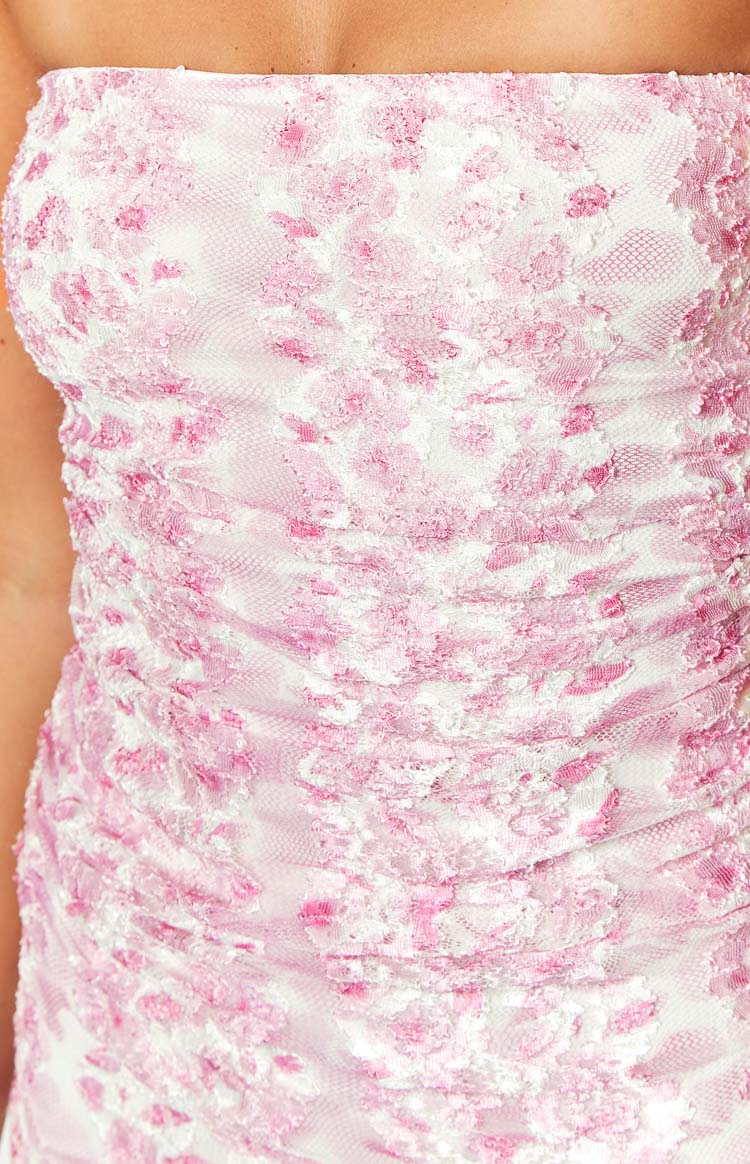 Close-up of the textured pink floral print and ruched detail on the white strapless maxi dress