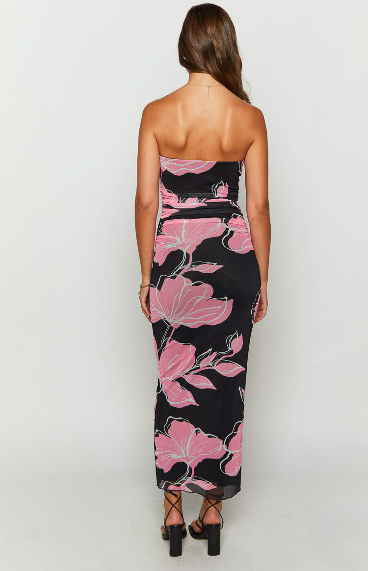 Rear view of a black strapless maxi dress with pink floral print and ruched back