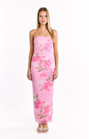 The side view of a strapless pink maxi-dress with a ruched bodice and a flowing skirt- adorned with a large pink and green floral print.
