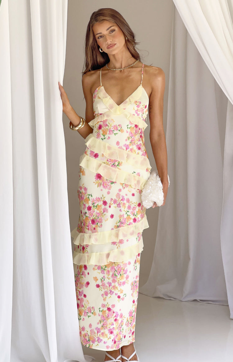 Full front view of a yellow bloom floral print maxi dress with V-neck, spaghetti straps, and tiered ruffles