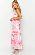 Side view of a pink floral print maxi dress with tiered ruffles on the bodice and skirt, showing side cutouts