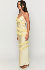 Side view of a yellow satin maxi dress with tiered ruffles and a V-neck with thin spaghetti straps