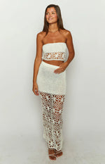 White crochet high-waisted maxi skirt with a fitted silhouette and floral cutout pattern at the hem