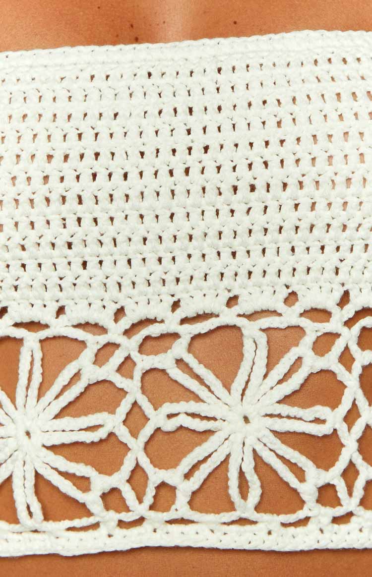 Close-up of the white crochet crop top showing the open knit and floral lace patterns