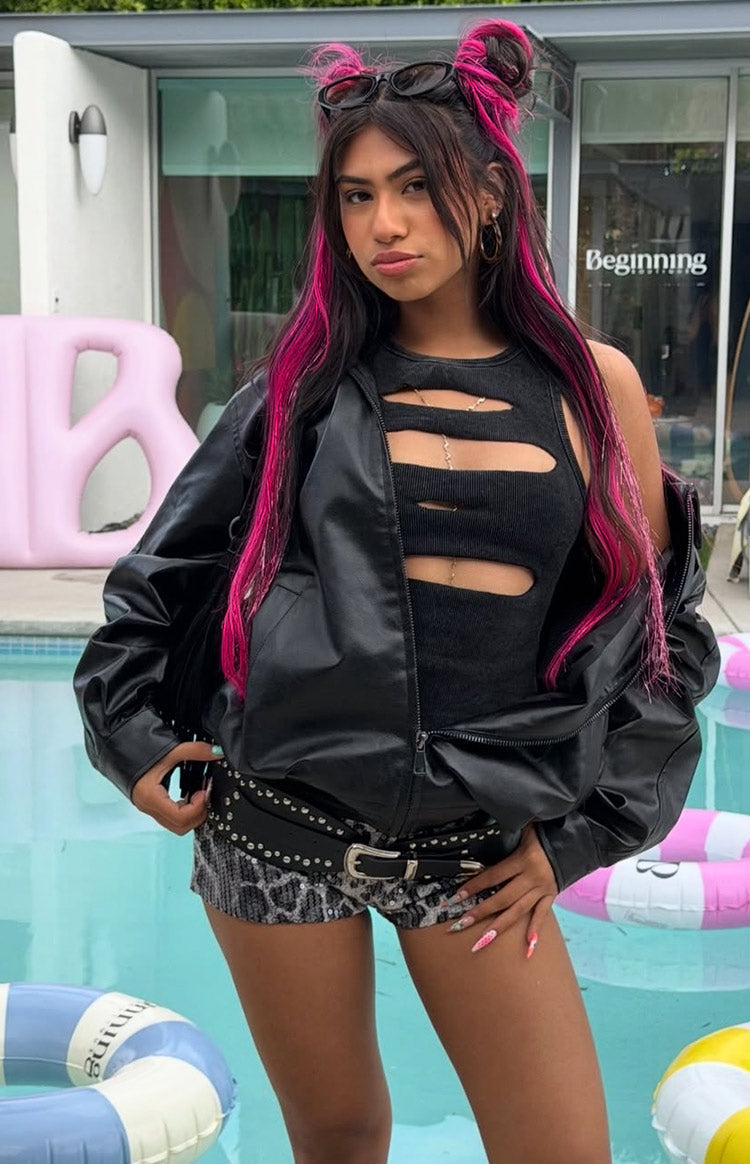 Black PU bomber jacket worn open with sleeves pushed up, showing the front zipper and relaxed fit