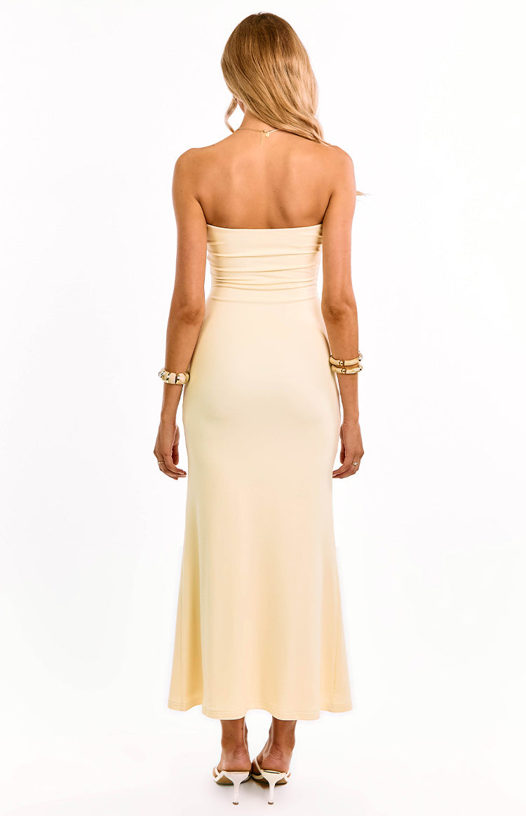 Rear view of a cream strapless maxi dress with a fitted bodice and a smooth, flowing maxi skirt