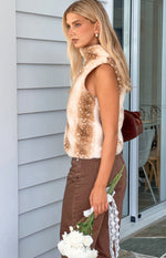 Side view of a brown deer print high neck fur top with a plush texture and sleeveless design