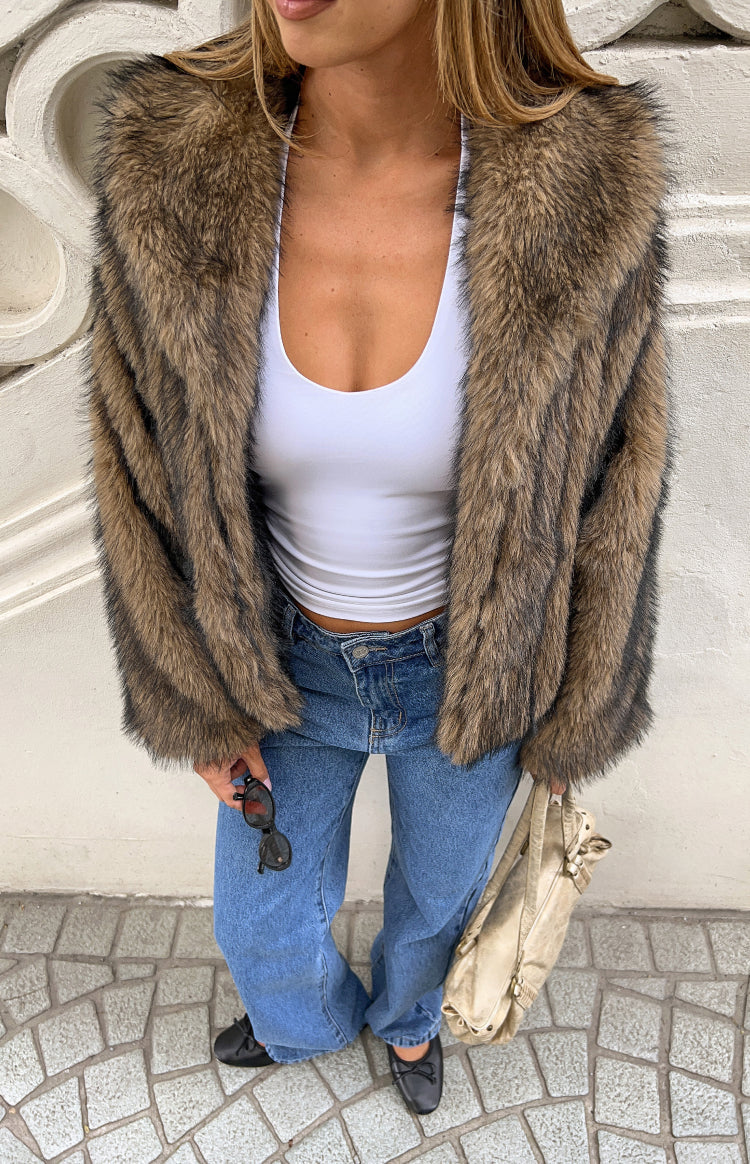 Top-down view of a chocolate brown faux fur jacket with wide lapels and a striped texture
