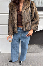 Open front view of a chocolate faux fur jacket with wide lapels and a textured finish