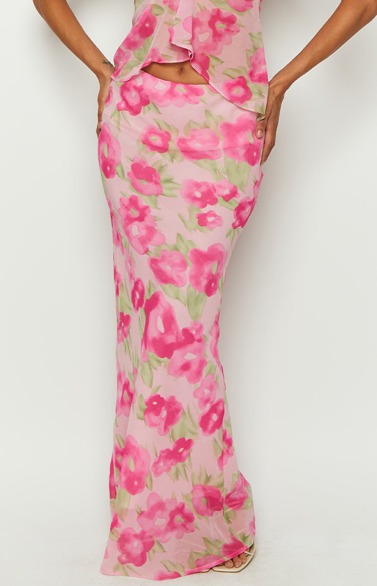 Close-up of the pink floral print maxi skirt, showing the fitted waist and flowy sheer fabric