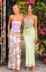 Yellow bloom print strapless top with a twisted front bust and sheer flowy overlay