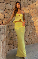 Yellow maxi skirt with a flowy silhouette and high waist, showing the full length