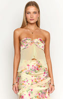 Beginning Boutique Jacqulin Yellow Bloom Strapless Top yellow floral strapless top with bow bust and sheer asymmetric overlay