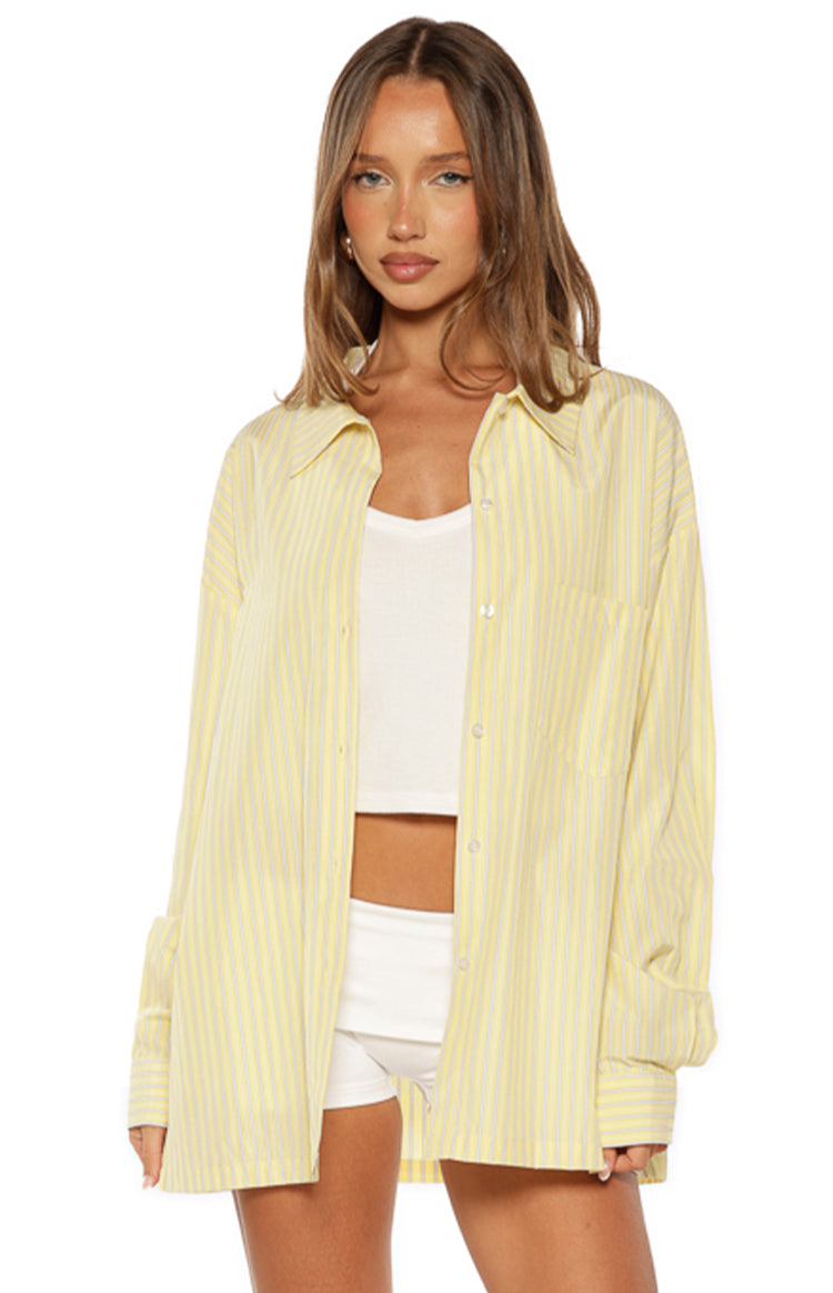 Yellow and white striped long sleeve shirt with a collared neckline, button-up front, and single chest pocket