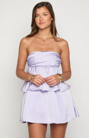 Lilac satin strapless mini dress with a gathered bodice and a tiered peplum waist