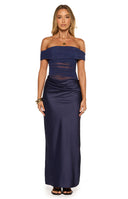 Model in an elegant navy blue off shoulder maxi dress with ruched mesh detailing perfect for a Formal event or as a Wedding Guest outfit