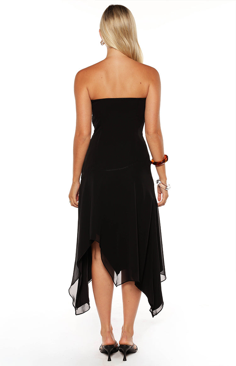 Rear view of a black strapless midi dress showing the hanky hem and flowy skirt