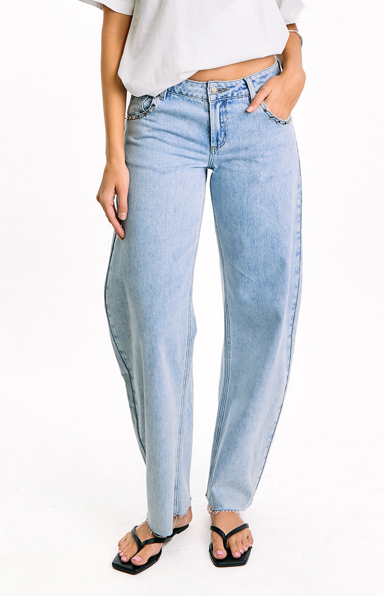 Beginning Boutique Jannina Light Wash Denim Studded Low Rise Jeans light wash denim studded low rise wide leg jeans with frayed hem