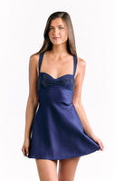 An elegant blue satin mini-dress with a sweetheart neckline and a contrasting textured panel on the bust. The dress has thin spaghetti straps and an A-line skirt.