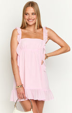 Light pink mini dress with ruffled straps, square neckline, gathered empire waist, and side ruffles