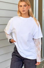 White long sleeve tee with sheer floral lace sleeves, layered under a short sleeve tee