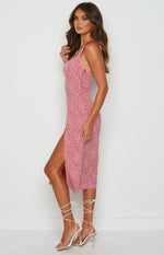 Red midi dress with white floral print, sweetheart neckline, ruffled shoulder straps, and high side split