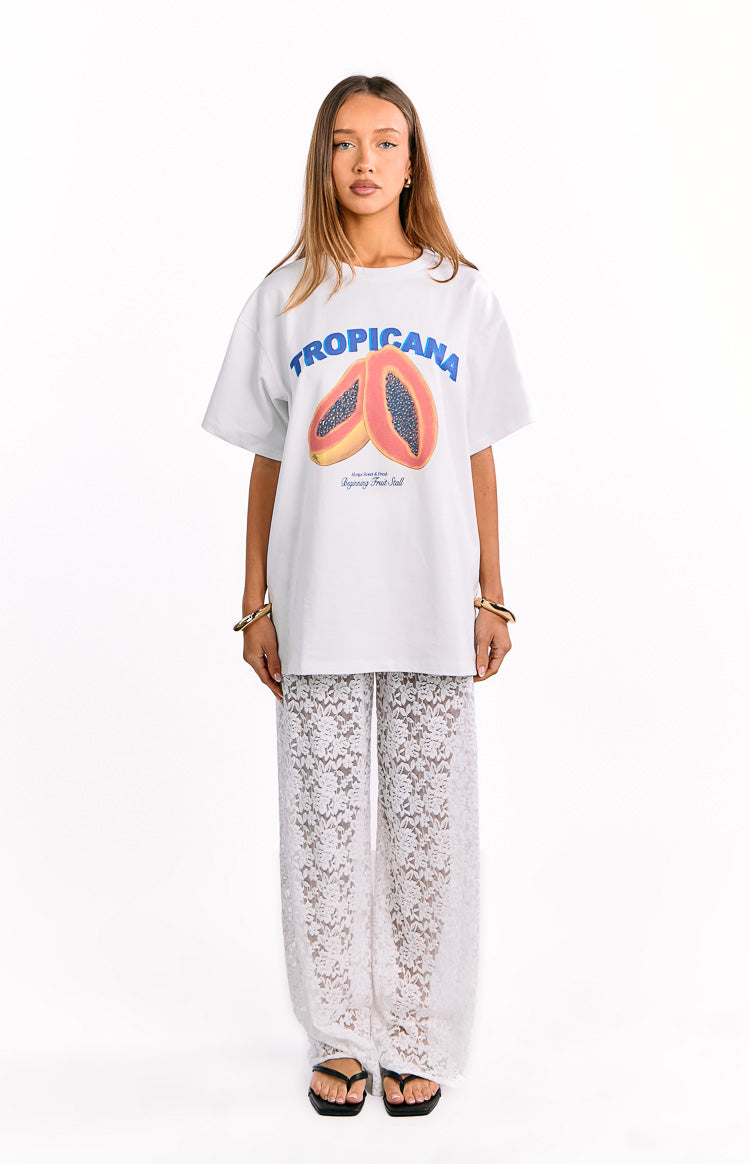 Full length view of white wide-leg pants with an intricate floral lace pattern