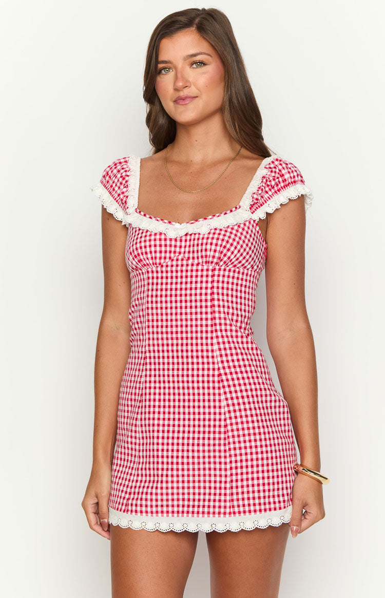 Front view of a red and white gingham mini dress with a square neckline, white lace trim, and short puff sleeves