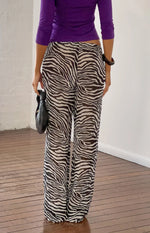 Rear view of black sheer zebra print pants with a relaxed wide leg and elasticated waist