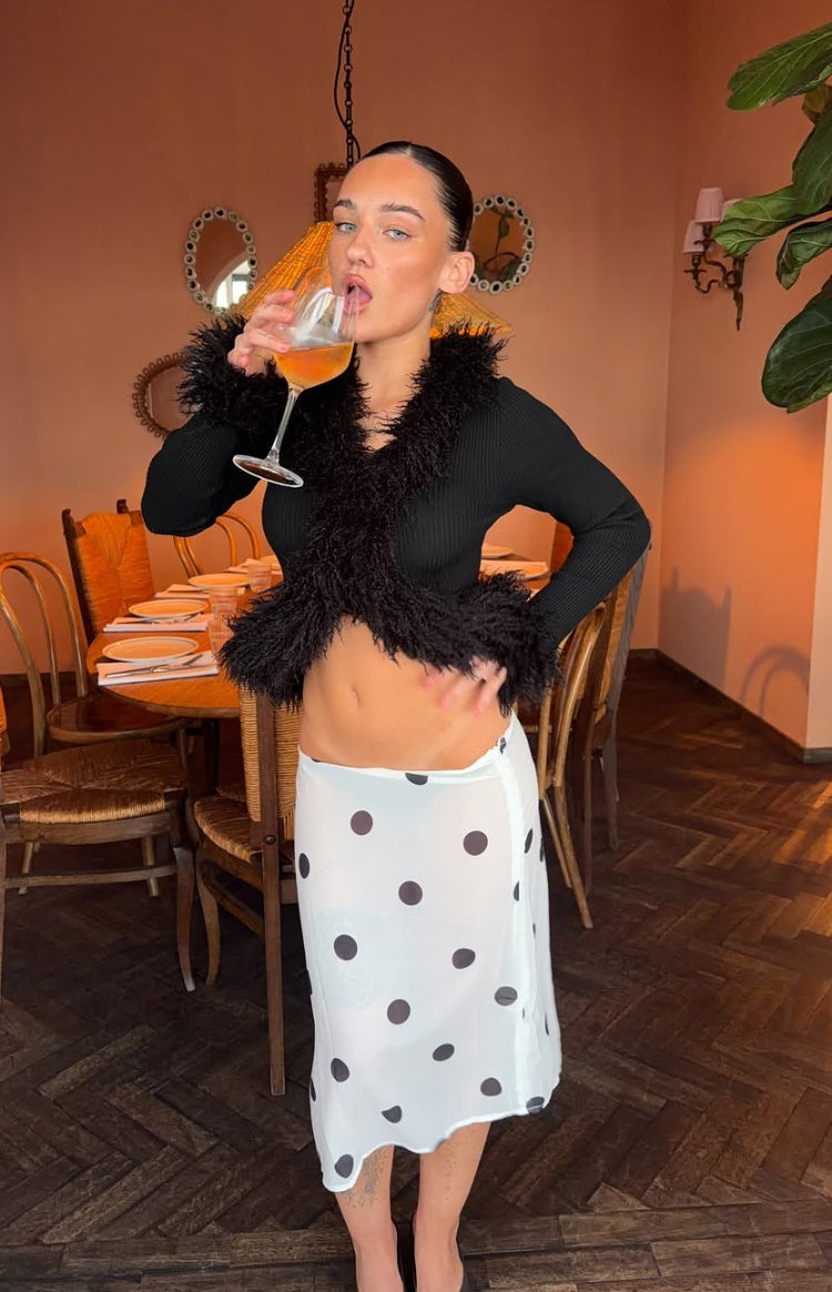 White sheer polka dot midi skirt with a relaxed fit and dark dots