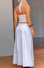 Rear view of a white gathered waist maxi skirt with a flowy silhouette