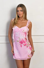 Pink floral chiffon mini dress with a sweetheart neckline, front bow detail, and ruffled shoulder straps