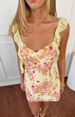 Yellow floral chiffon mini dress with a sweetheart neckline, small bow detail at the bust, and ruffled shoulder straps