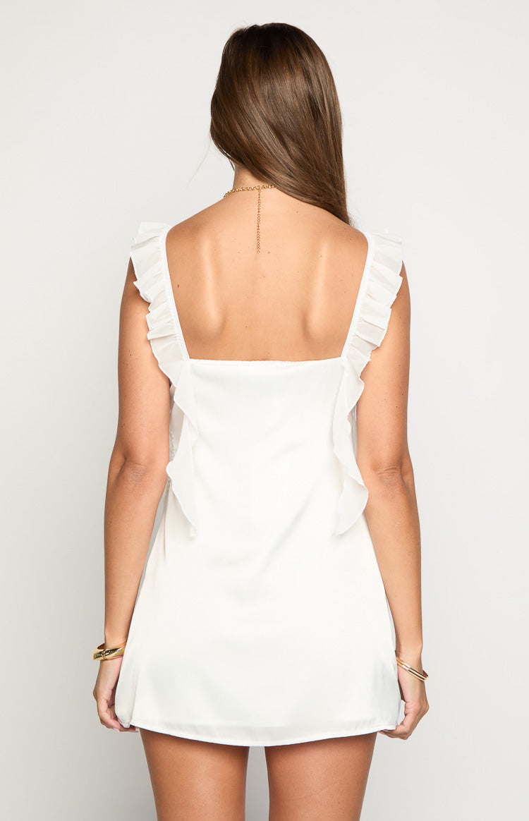 Rear view of a white satin mini dress with a square back and ruffled shoulder straps