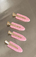 Four pink polka dot non-crease hair clips with gold metal clasps
